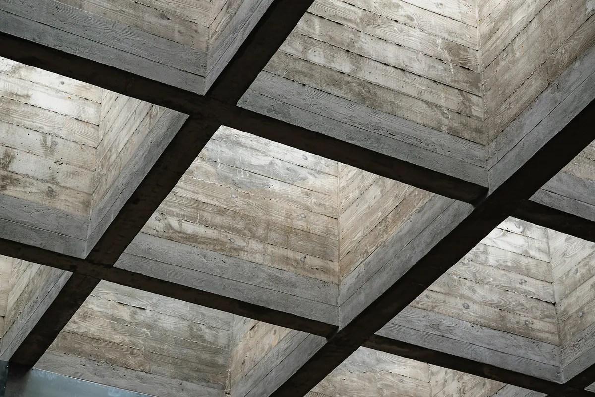 A coffered concrete ceiling, the marks of the timber boards it was poured against in every bay