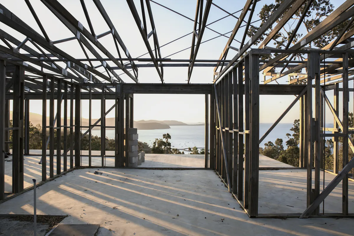 The steel frame of a house with a view to the water