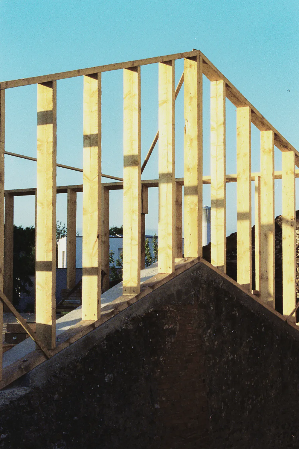 New timber wall studs against a blue sky
