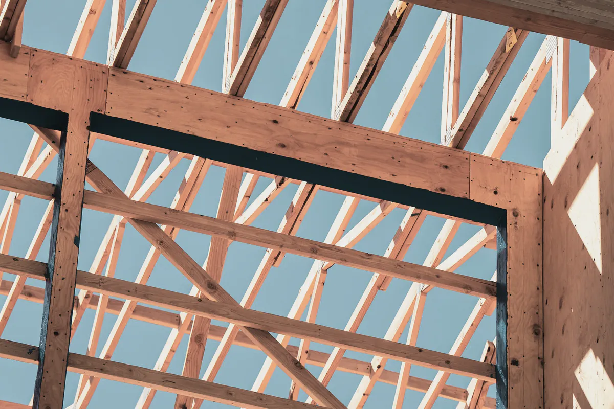 Timber trusses and a wall frame seen from below